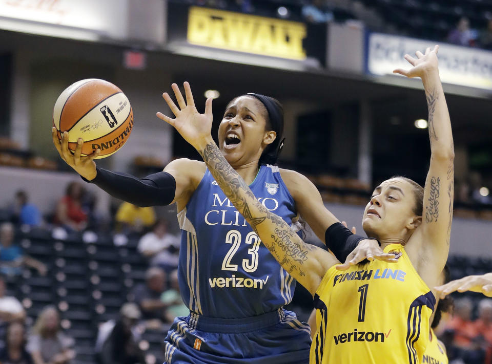 FILE - In this Aug. 30, 2017, file photo, Minnesota Lynx's Maya Moore, left, shoots against Indiana Fever's Jazmon Gwathmey during the first half of a WNBA basketball game in Indianapolis. Moore shocked the basketball world when she stepped away from the WNBA earlier in 2019 before the season began. She’s spent a lot of her time away from the game trying to help a family friend, Jonathan Irons, get his conviction overturned. (AP Photo/Darron Cummings, File)