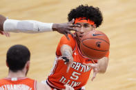 Illinois guard Andre Curbelo (5) passes to forward Giorgi Bezhanishvili during the first half of an NCAA college basketball game against Michigan State, Tuesday, Feb. 23, 2021, in East Lansing, Mich. (AP Photo/Carlos Osorio)