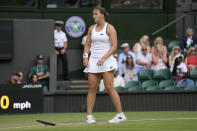 Germany's Jule Niemeier drops her racket after winning match point against Britain's Heather Watson in a women's fourth round singles match on day seven of the Wimbledon tennis championships in London, Sunday, July 3, 2022. (AP Photo/Kirsty Wigglesworth)