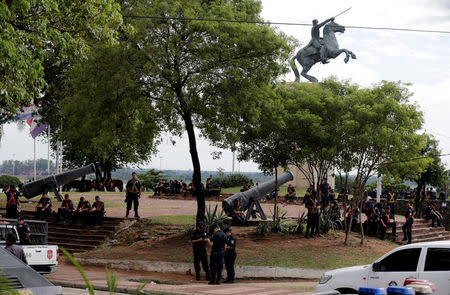 Police officers gather near the Congress building before a demonstration against a proposed amendment that would allow Paraguay's president to stand for re-election, in Asuncion, Paraguay April 4, 2017. REUTERS/Jorge Adorno