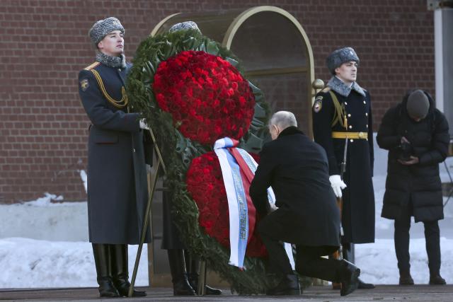 Russian President Vladimir Putin, center right, attends a wreath-laying ceremony at the Tomb of the Unknown Soldier, near the Kremlin Wall during the national celebrations of the "Defender of the Fatherland Day" in Moscow, Russia, Thursday, Feb. 23, 2023. The Defenders of the Fatherland Day, celebrated in Russia on Feb. 23, honors the nation's military and is a nationwide holiday. (Valery Sharifulin, Sputnik, Kremlin Pool Photo via AP)