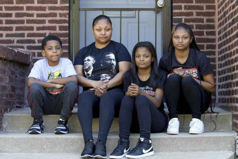 In this Sept. 26, 2021, photo Krystal Archie poses for a photograph with her three children Jhaimarion, left, Telia, second from right, and Savannah on Chicago's South Side. The children were just 7, 11 and 14 years old when on two occasions just 11 weeks apart police kicked open their front door and ordered them to get down on the floor. (AP Photo/Teresa Crawford)