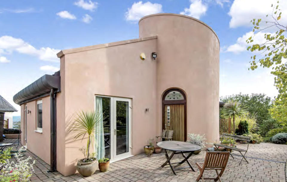 The house stood out for its pale pink curving walls and corkscrew staircase tower.
(Bradleys Estate Agents/SWNS)