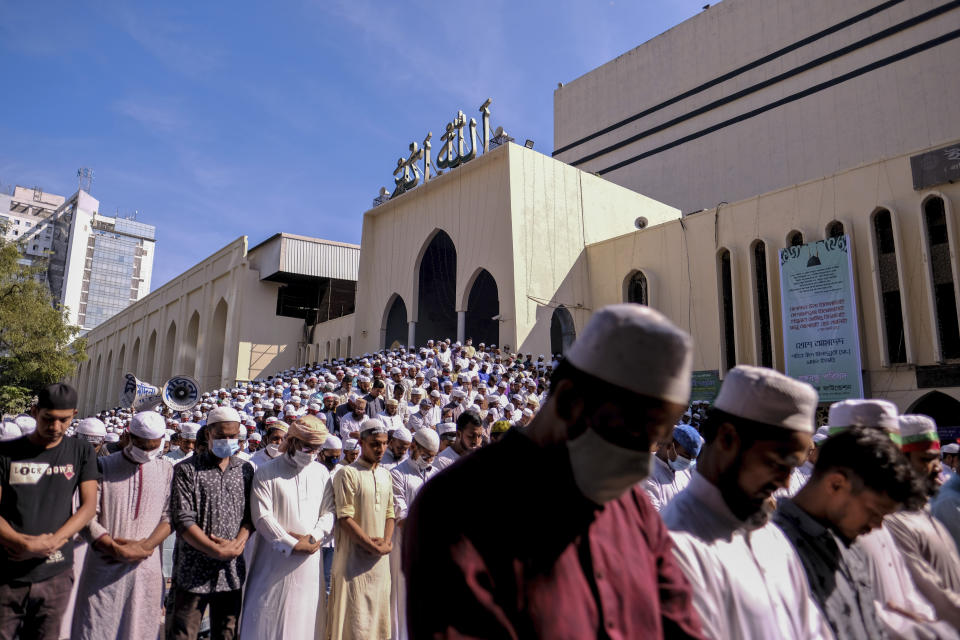 Supporters of several Islamist parties offer prayers in front of the main Baitul Mokarram national mosque in Dhaka, Bangladesh, Friday, Oct. 30, 2020. After weekly Friday prayers, thousands of Muslims and activists marched through streets and rallied across Bangladesh’s capital on Friday against the French president’s support of secular laws that deem caricatures of the Prophet Muhammad as protected under freedom of speech. (AP Photo/Mahmud Hossain Opu)