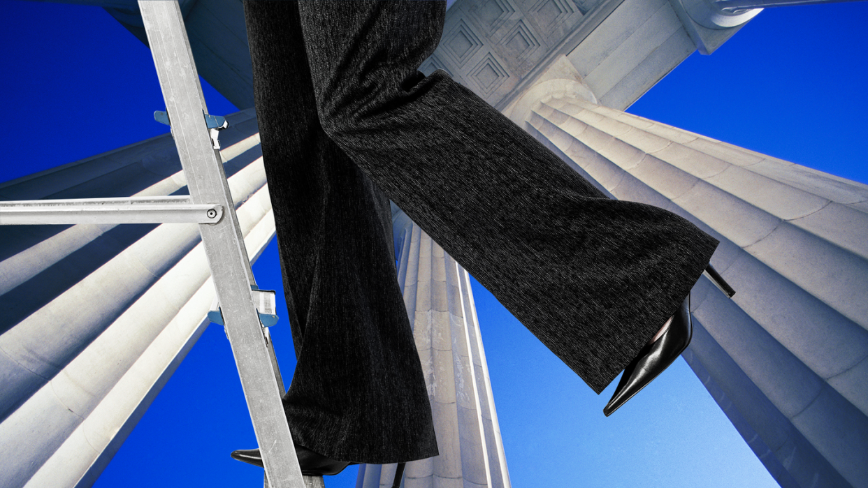 a person wearing a black jacket and black pants standing on a metal pole