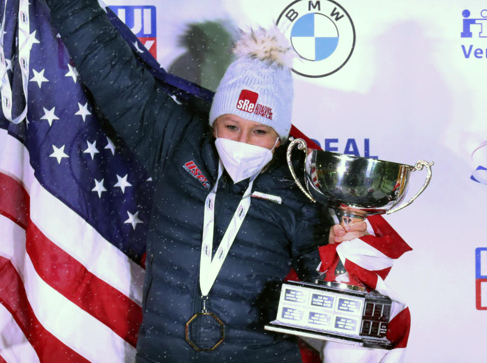 FILE - In this Feb. 6, 2021, file photo, Kaillie Humphries celebrates after winning with Lolo Jones the two-women's bobsled race at the Bobsled and Skeleton World Championships in Altenberg, Germany. Reigning women’s world bobsled champion and three-time Olympic medalist Humphries of the U.S. has asked the International Olympic Committee for a solution that would allow her to compete in this winter’s Beijing Games even though her American citizenship will not be finalized. (AP Photo/Matthias Schrader, File)