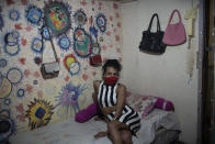 Venezuelan transgender Vanessa poses for a photo inside her room at the squat known as Casa Nem, occupied by members of the LGBTQ community who are in self-quarantine as a protective measure against the new coronavirus, in Rio de Janeiro, Brazil, Saturday, May 23, 2020. (AP Photo/Silvia Izquierdo)