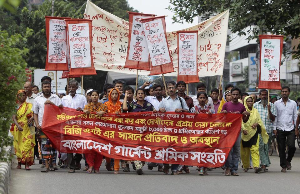 Bangladeshi garment workers, activists and relatives of workers participate in a protest marking the four-month anniversary of the Rana Plaza building collapse in Dhaka, Bangladesh in August 2013. (AP Photo/A.M. Ahad)
