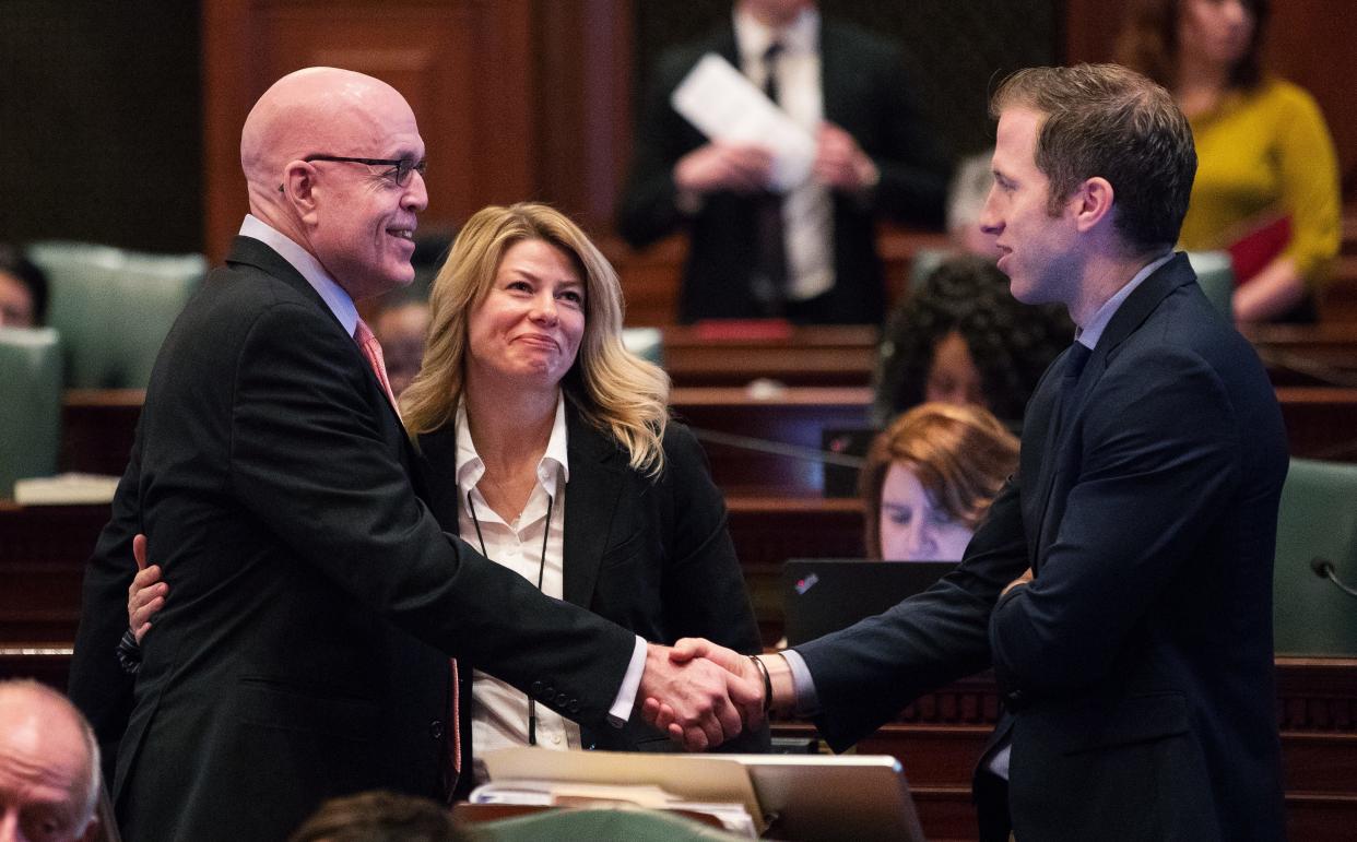 Jessica Basham looks on as Illinois Rep. Greg Harris, D-Chicago, is congratulated by Craig Willert, House Democrats' Director of Issues Development Unit, right, in a 2017 file photo. Springfield city council will vote on Basham becoming a lobbyist for the city.