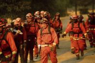 <p>Inmate firefighters leave an assignment while battling a wildfire in Guinda, Calif., July 1, 2018. (Photo: Noah Berger/AP) </p>