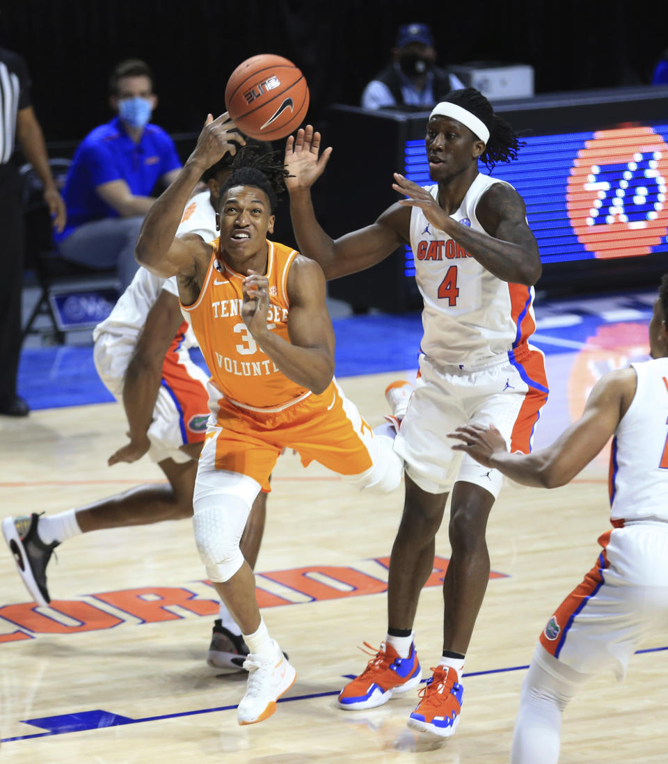 Tennessee guard Yves Pons (35) shoots past Florida forward Anthony Duruji (4) during the first half of an NCAA college basketball game Tuesday, Jan. 19. 2021, in Gainesville, Fla. (AP Photo/Matt Stamey)