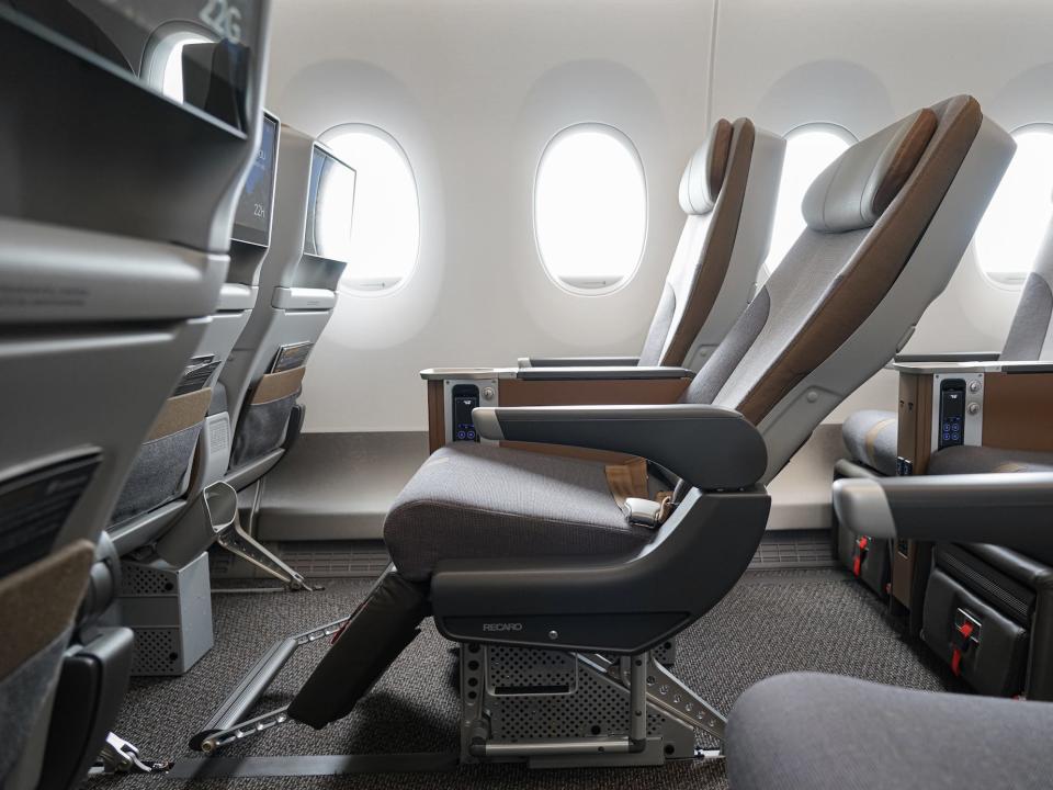 Starlux Airlines premium economy seat recline with legrest and footrest out.