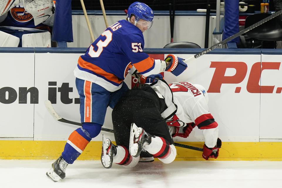 New York Islanders' Casey Cizikas (53) checks New Jersey Devils' Yegor Sharangovich (17) during the second period of an NHL hockey game Saturday, May 8, 2021, in Uniondale, N.Y. Cizikas was penalized for boarding. (AP Photo/Frank Franklin II)