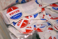 A bin of "I Voted Today" stickers rests on a table at a polling place, Tuesday, Sept. 13, 2022, in Stratham, N.H. (AP Photo/Charles Krupa)