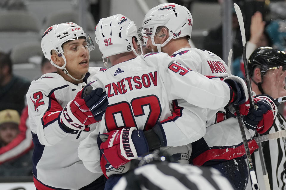 Washington Capitals center Evgeny Kuznetsov, middle, is congratulated by defenseman Martin Fehervary, left, and right wing Anthony Mantha after scoring against the San Jose Sharks during the second period of an NHL hockey game in San Jose, Calif., Monday, Nov. 27, 2023. (AP Photo/Jeff Chiu)