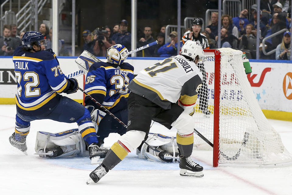 St. Louis Blues goaltender Ville Husso (35) and Justin Faulk (72) are unable to prevent Vegas Golden Knights' Jonathan Marchessault (81) from scoring a goal during the third period of an NHL hockey game Friday, April 29, 2022, in St. Louis. (AP Photo/Scott Kane)