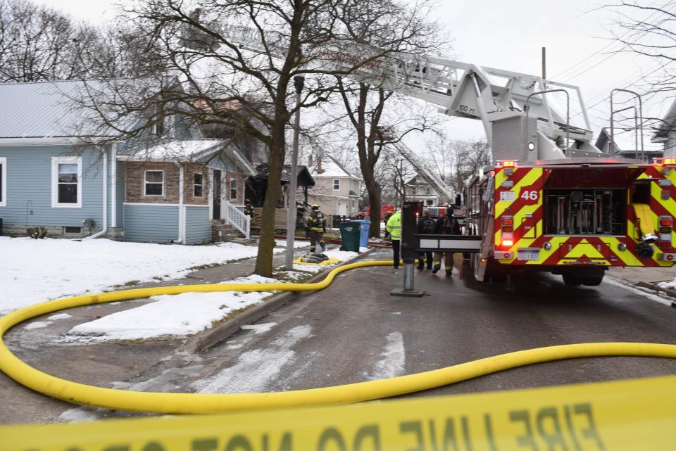 Firefighters with the Lansing Fire Department work at the scene at a fatal fire in the 500 block of Rulison in Lansing.