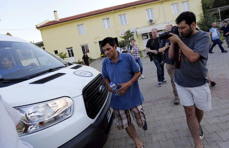 Abdullah Kurdi, father of three-year-old Aylan Kurdi (2nd R), leaves from of a morgue in Mugla, Turkey, September 3, 2015. REUTERS/Murad Sezer