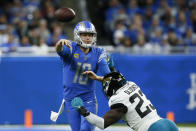 Detroit Lions quarterback Jared Goff (16) is pressured by Jacksonville Jaguars linebacker Foyesade Oluokun (23) during the first half of an NFL football game, Sunday, Dec. 4, 2022, in Detroit. (AP Photo/Duane Burleson)