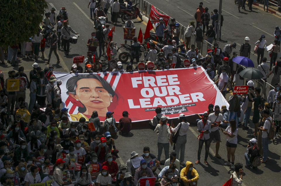 Demonstrators display a banner with an image of deposed Myanmar leader Aung San Suu Kyi during a protest against the military coup in Yangon, Myanmar, Wednesday, Feb. 17, 2021. The U.N. expert on human rights in Myanmar warned of the prospect for major violence as demonstrators gather again Wednesday to protest the military's seizure of power. (AP Photo)