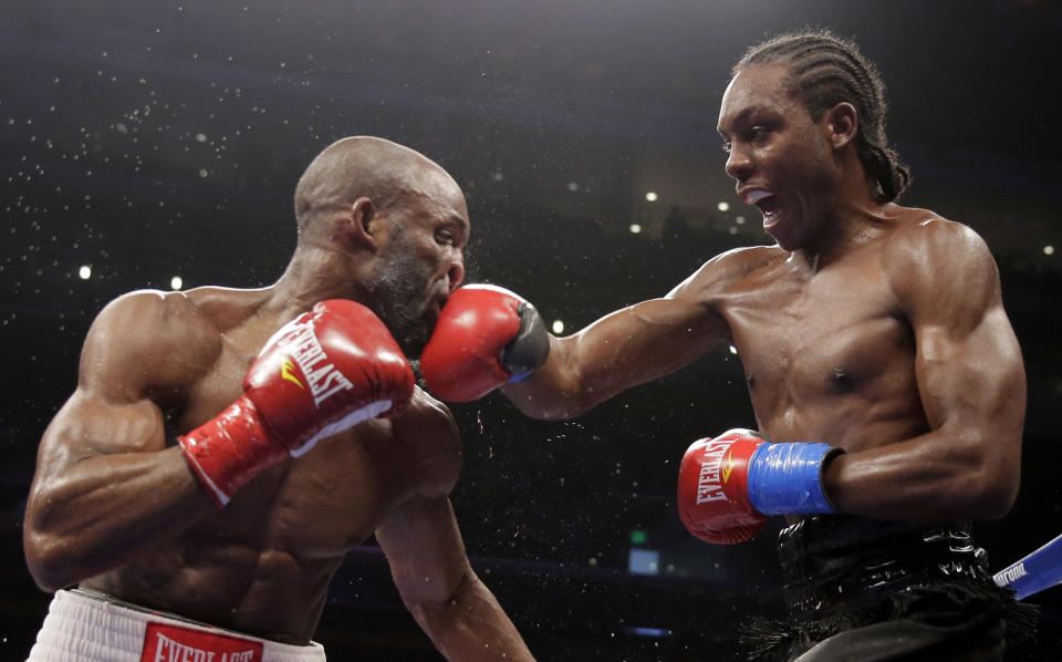 Amir Imam, right, hits Yordenis Ugas during their super lightweight boxing match in Los Angeles, Saturday, May 10, 2014. Imam won the bout. (AP Photo/Chris Carlson)