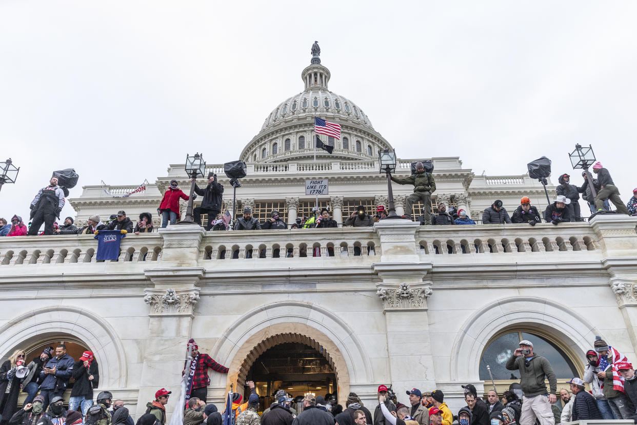 Protesters gather at the Capitol building where pro-Trump supporters riot and breached the Capitol in an attempt to overthrow the results of the 2020 election. 