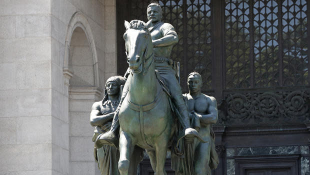 A statue of Theodore Roosevelt on horseback flanked by a Native American and an African, in front of the American Museum of Natural History in New York City, June 22, 2020. The statue, which was installed in 1940, will be taken down after objections that it symbolizes colonial expansion and racial discrimination. / Credit: Kathy Willens/AP