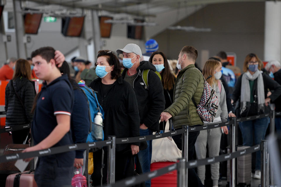 Passengers are seen lining up to check in at Sydney Domestic Airport.