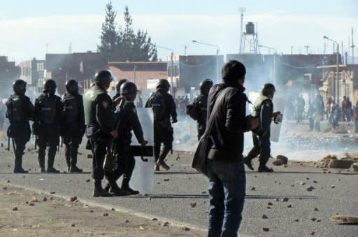 Peruvian anti-riot police confront some 1,000 protesters, mostly local Aymara Indian farmers, trying to reach Juliaca's airport, 1,400 km southeast of Lima in Puno region, on June 24. Peru's government took legal steps Saturday to suspend a Canadian company's silver mining concession in the wake of deadly protests by mostly indigenous anti-mining demonstrators, authorities said