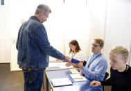 Gunnar Smari Egilsson, candidate for the Socialist Party, casts his vote in Reykjavik, Iceland, Saturday, Sept. 25, 2021. Icelanders are voting in a general election dominated by climate change, with an unprecedented number of political parties likely to win parliamentary seats. (AP Photo/Brynjar Gunnarsson)