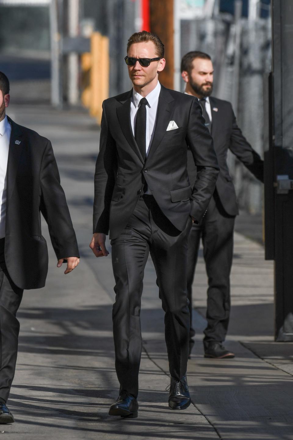 <p>Tom Hiddleston is a man who can do both but, let’s be real, dressing up is his true strength. He can wear a <a rel="nofollow noopener" href="http://www.gq.com/gallery/tom-hiddleston-style-look-book-suits?mbid=synd_yahoostyle#2" target="_blank" data-ylk="slk:cranberry double-breasted suit;elm:context_link;itc:0;sec:content-canvas" class="link ">cranberry double-breasted suit</a> or a <a rel="nofollow noopener" href="http://www.gq.com/story/tom-hiddleston-gucci-suit-kong-red-carpet?mbid=synd_yahoostyle" target="_blank" data-ylk="slk:sober navy two-button style;elm:context_link;itc:0;sec:content-canvas" class="link ">sober navy two-button style</a> or some <a rel="nofollow noopener" href="http://www.gq.com/gallery/tom-hiddleston-style-look-book-suits?mbid=synd_yahoostyle#7" target="_blank" data-ylk="slk:ye-ole-English three-piece kit;elm:context_link;itc:0;sec:content-canvas" class="link ">ye-ole-English three-piece kit</a> with equal charm. He can wear <a rel="nofollow noopener" href="http://www.gq.com/story/tom-hiddleston-aquatalia-boots?mbid=synd_yahoostyle" target="_blank" data-ylk="slk:flat-front chinos;elm:context_link;itc:0;sec:content-canvas" class="link ">flat-front chinos</a>, and <a rel="nofollow noopener" href="http://www.gq.com/gallery/tom-hiddleston-style-look-book-suits?mbid=synd_yahoostyle#11" target="_blank" data-ylk="slk:notch-lapel blazers;elm:context_link;itc:0;sec:content-canvas" class="link ">notch-lapel blazers</a>, and <a rel="nofollow noopener" href="http://www.gq.com/story/tom-hiddleston-dress-shirt-pink?mbid=synd_yahoostyle" target="_blank" data-ylk="slk:weird-color button-down shirts;elm:context_link;itc:0;sec:content-canvas" class="link ">weird-color button-down shirts</a>. Basically, if it’s respectable enough to wear in an office, he’s done it and he’s knocked it out of the park. Cementing his status as an office style hero was this Gucci look, which Hiddleston wore on <em>Jimmy Kimmel Live</em> yesterday. Just when you thought the man had dressed up in every possible way, he goes all <em>Reservoir Dogs</em> on us; walking in slow-motion in some back alley while wearing a slim black suit and Ray-Bans.</p><p>If you are an accountant, or an agent, or an assistant of an accountant or an agent, let this look be your work wardrobe inspiration. If you are in another field, well, rest assured there’s a Hiddleston look for you.</p>