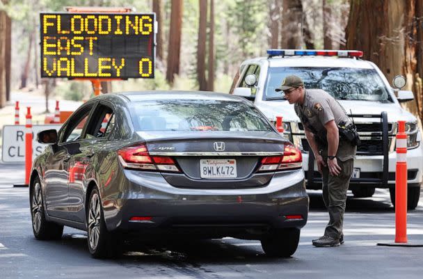 PHOTO: A park ranger speaks to a driver at a checkpoint for a road closed due to flooding in Yosemite Valley, as warming temperatures have increased snowpack runoff, April 29, 2023, in Yosemite National Park, Calif. (Mario Tama/Getty Images, FILE)