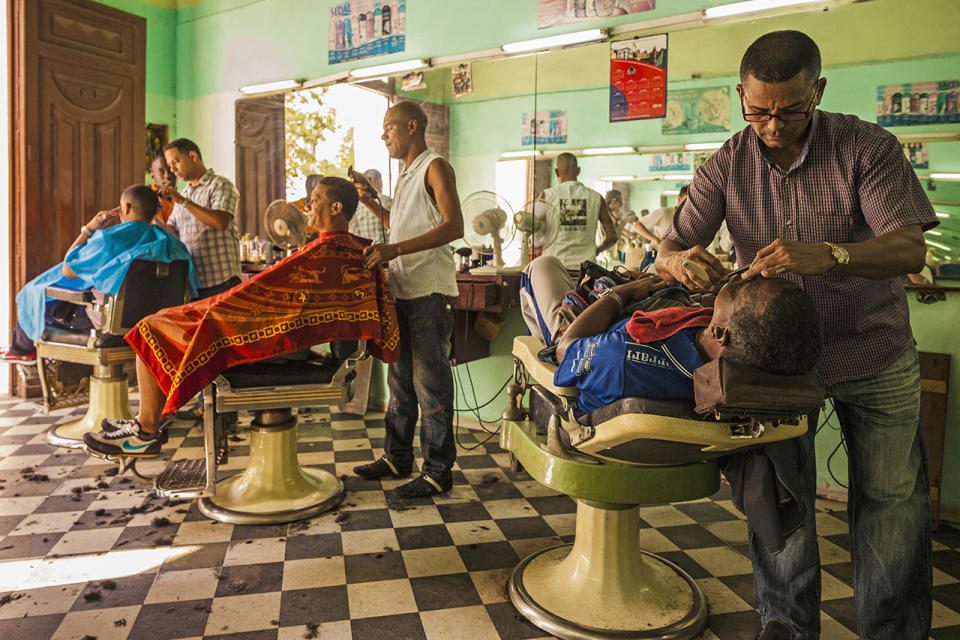 <p>Barber chairs are all occupied at this barbershop in Camagüey, Cuba. </p>