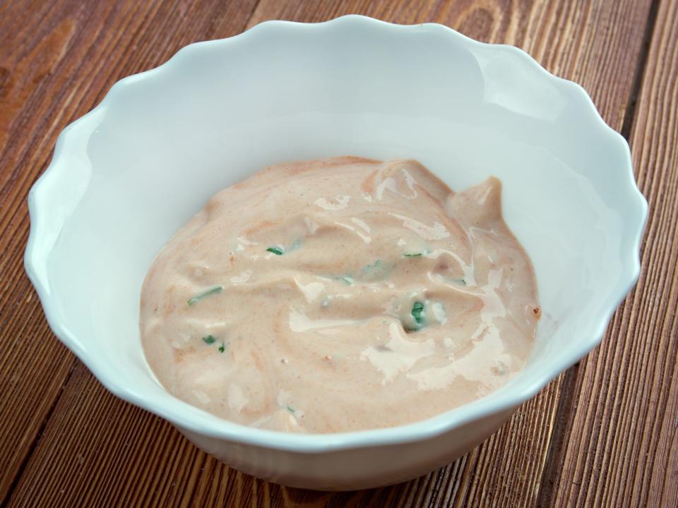 thousand island dressing in a scalloped white bowl