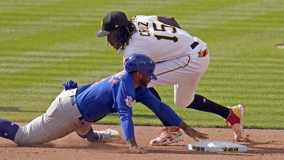 Chicago Cubs' Nelson Velazquez is tagged out attempting to steal second by Pittsburgh Pirates shortstop Oneil Cruz (15) during the seventh inning of a baseball game in Pittsburgh, Sunday, Sept. 25, 2022. (AP Photo/Gene J. Puskar)