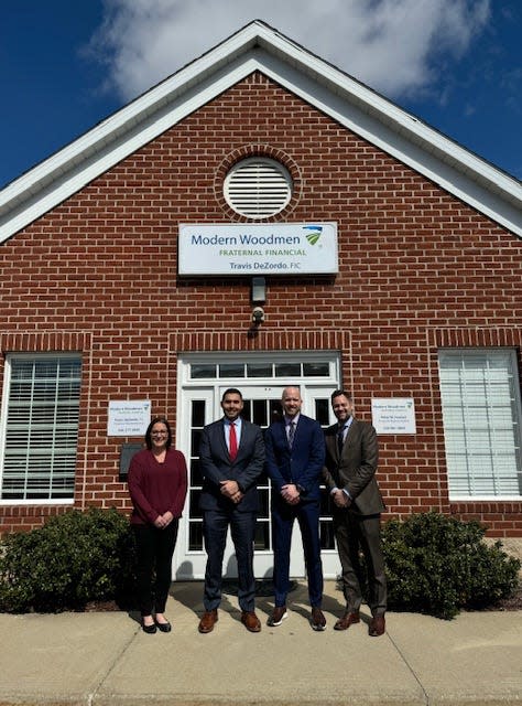 Lori Seckel, Travis DeZordo, Peter Husted and Brian Souder with Modern Woodmen in front of the new office in Lake Township.