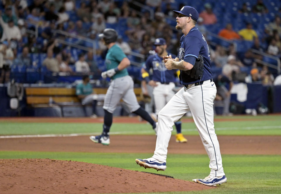 Tampa Bay Rays reliever Chris Devenski, right, walks back to the mound after giving up a two-run home run to Seattle Mariners' Mitch Garver, left, during the seventh inning of a baseball game Monday, June 24, 2024, in St. Petersburg, Fla. (AP Photo/Steve Nesius)