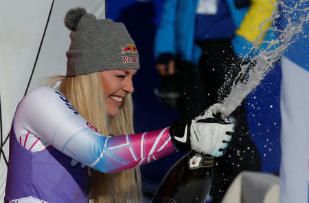 Skiing - Alpine Skiing World Cup - Women's Downhill - Cortina d'Ampezzo, Italy - January 20, 2018. Lindsey Vonn celebrates on the podium. REUTERS/Stefano Rellandini