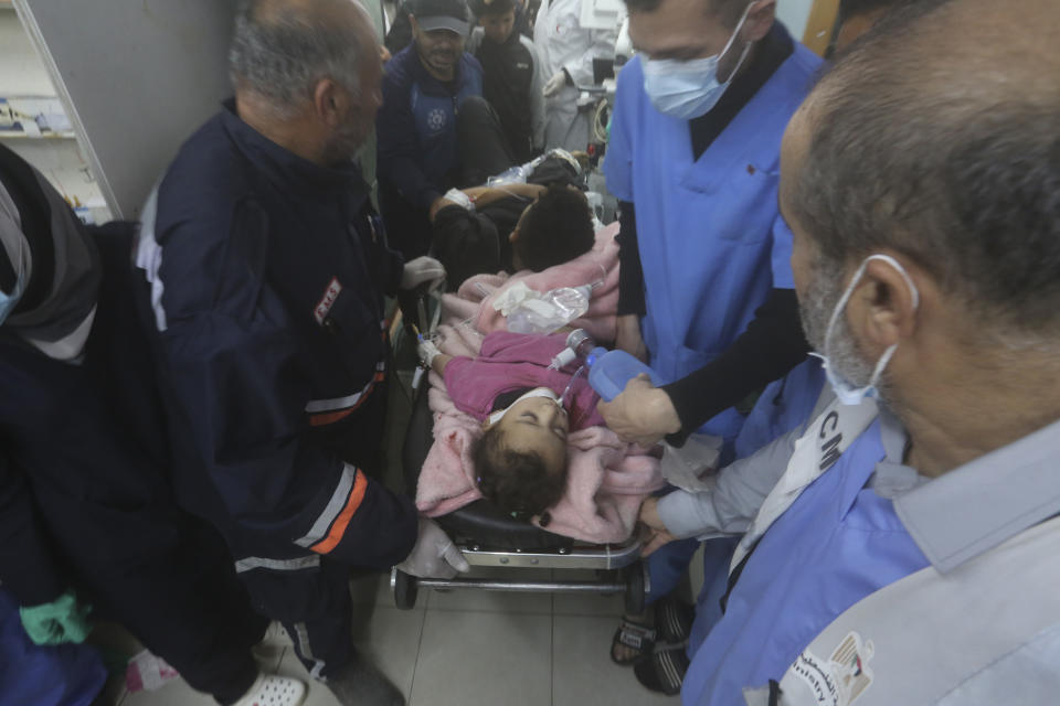 Palestinians wounded during the Israeli air and ground offensive in Khan Younis are brought to a hospital in Rafah, Gaza Strip, Tuesday, Jen. 23, 2024. (AP Photo/Hatem Ali)