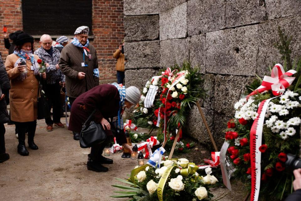 Holocaust survivors and former Auschwitz inmates attend a wreath lying ceremony in front of the Death Wall in the former Nazi German concentration and extermination camp Auschwitz during ceremonies marking the 78th anniversary of the liberation of the camp in Oswiecim, Poland, Friday, Jan. 27, 2023.