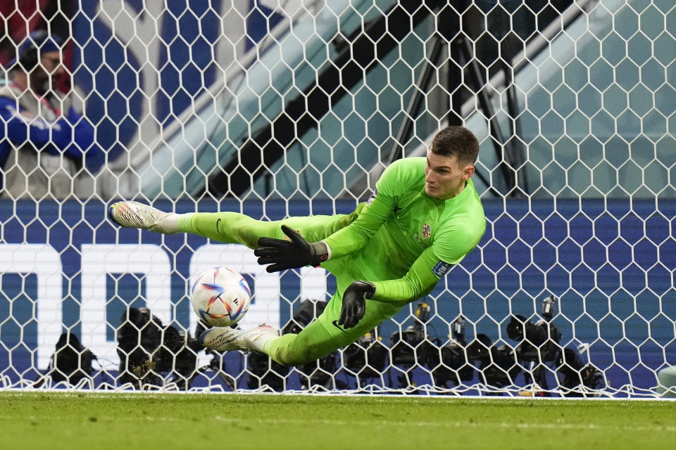 Croatia's goalkeeper Dominik Livakovic makes a save during the penalties shootout during the World Cup round of 16 soccer match between Japan and Croatia at the Al Janoub Stadium in Al Wakrah, Qatar, Monday, Dec. 5, 2022. Croatia won a penalty shootout 3-1 to qualify for the next round. (AP Photo/Alessandra Tarantino)