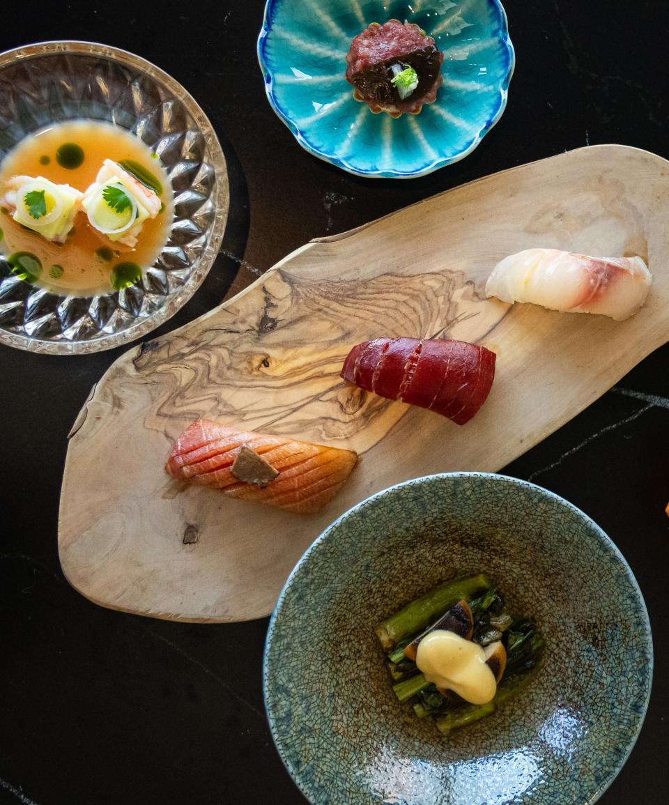 A spread of composed dishes and nigiri sushi served as part of the 22-course omakase menu at Craft Omakase.