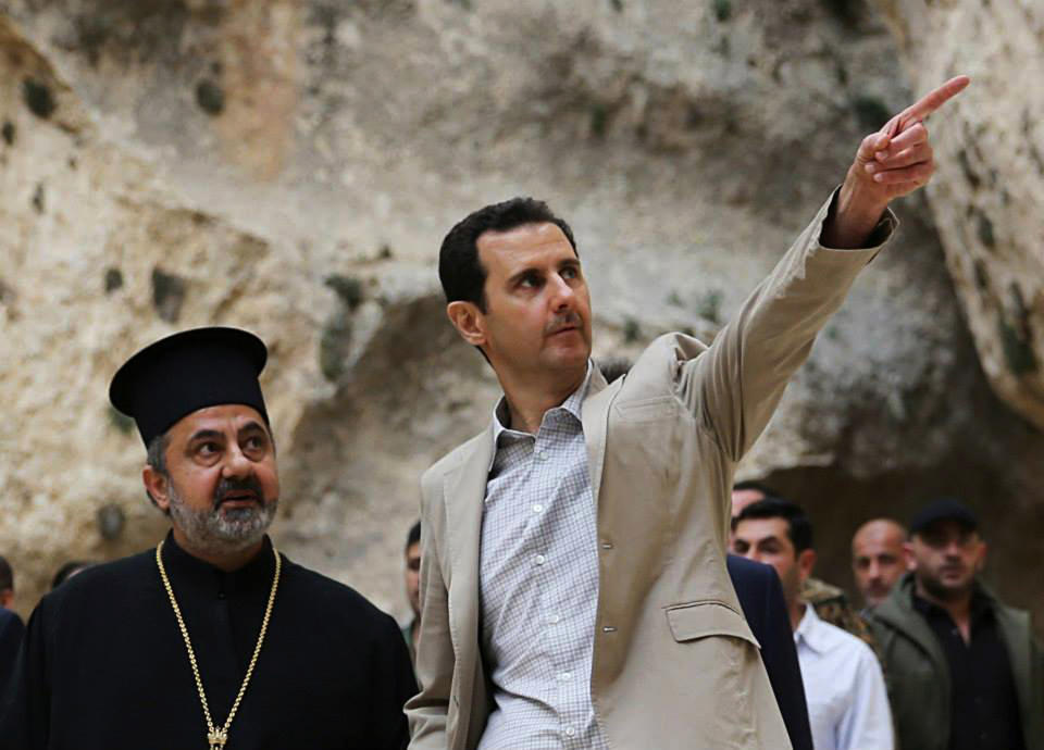 FILE - In this Sunday, April 20, 2014 file photo, released by the Syrian official news agency SANA, Syrian President Bashar Assad, right, visits the Christian village of Maaloula, near Damascus, Syria. Two years ago, it seemed almost inevitable that President Bashar Assad would be toppled. Almost no one thinks that now. As he prepares for elections through which he is set to claim another seven-year mandate for himself, the momentum in the civil war is clearly in Assad's favor. (AP Photo/SANA, File)