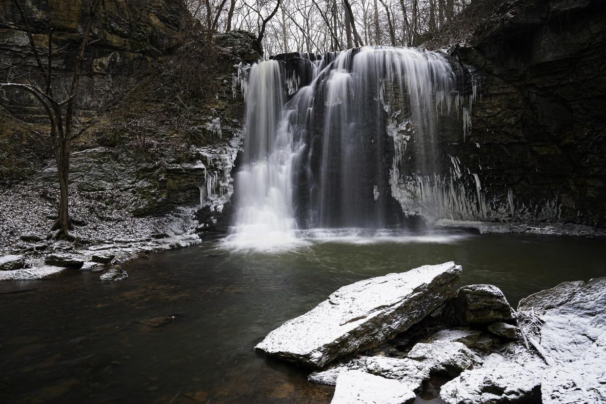 Water falls from a 35-foot waterfall as snow falls for the first time in 2022 at Hayden Falls Park in Columbus on January 6, 2022. Hayden Falls Park located within Griggs Nature Preserve, is on the West side of the Scioto River, just along Hayden Run Road, West of Griggs Reservoir bridge.