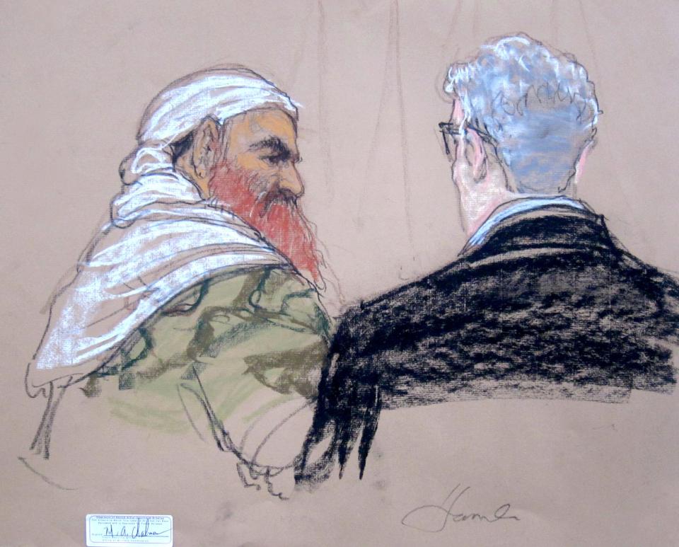 In this pool photo of a Pentagon-approved sketch by court artist Janet Hamlin, defendant Khalid Sheikh Mohammed, left, speaks with lead defense lawyer David Nevin during a pretrial hearing at the Guantanamo Bay U.S. Naval Base in Cuba, Monday, April 14, 2014. A lawyer for one of five defendants in the Sept. 11 war crimes tribunal said Monday that FBI agents questioned a member of his defense team, apparently in an investigation related to the handling of evidence, a revelation that brought an abrupt halt to proceedings. (AP Photo/Janet Hamlin, Pool)