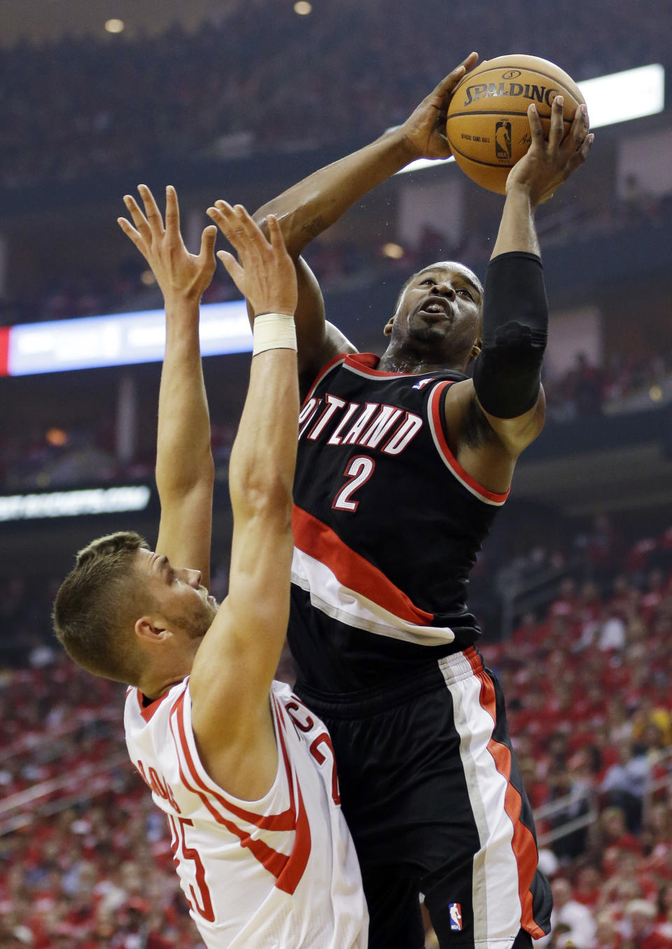 Portland Trail Blazers' Wesley Matthews (2) shoots over Houston Rockets' Chandler Parsons during the first half in Game 1 of an opening-round NBA basketball playoff series, Sunday, April 20, 2014, in Houston. (AP Photo/David J. Phillip)