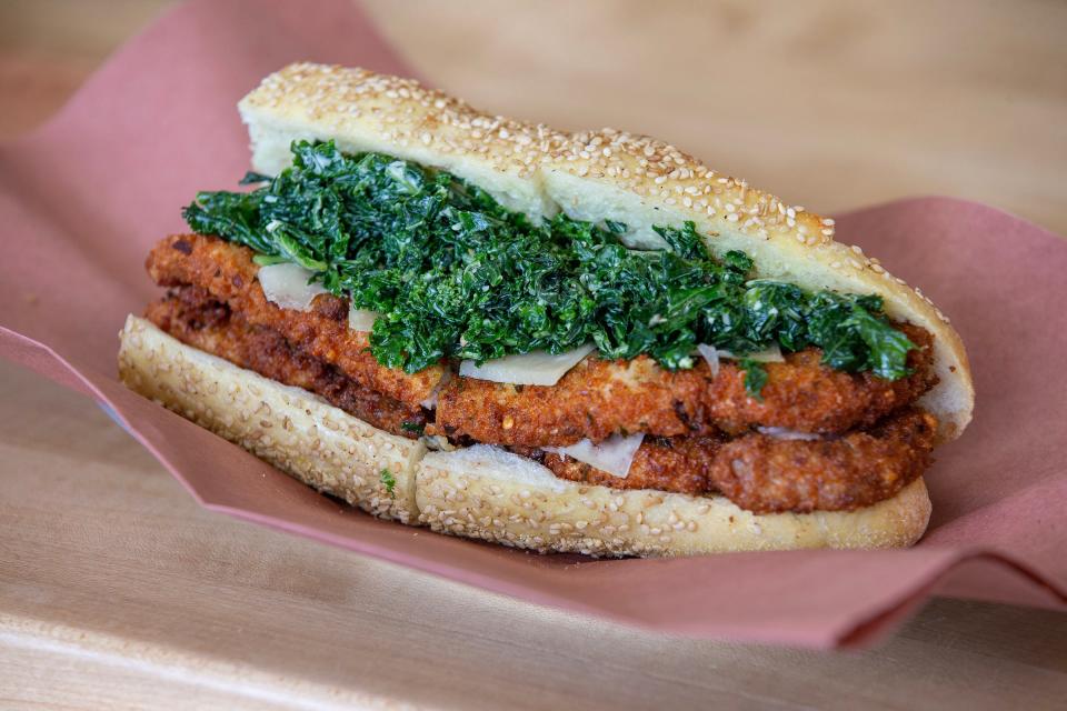 A pork cutlet sandwich with kale Caesar salad at Palmer's Quality Meats, a whole animal butcher shop in Neptune City that serves sandwiches several days a week.