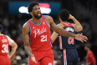 Philadelphia 76ers center Joel Embiid (21) reacts after he was called for a foul during the first half of an NBA basketball game against the Washington Wizards, Monday, Jan. 17, 2022, in Washington. The play was reviewed and reversed and the foul charged to Wizards center Daniel Gafford (21). (AP Photo/Nick Wass)