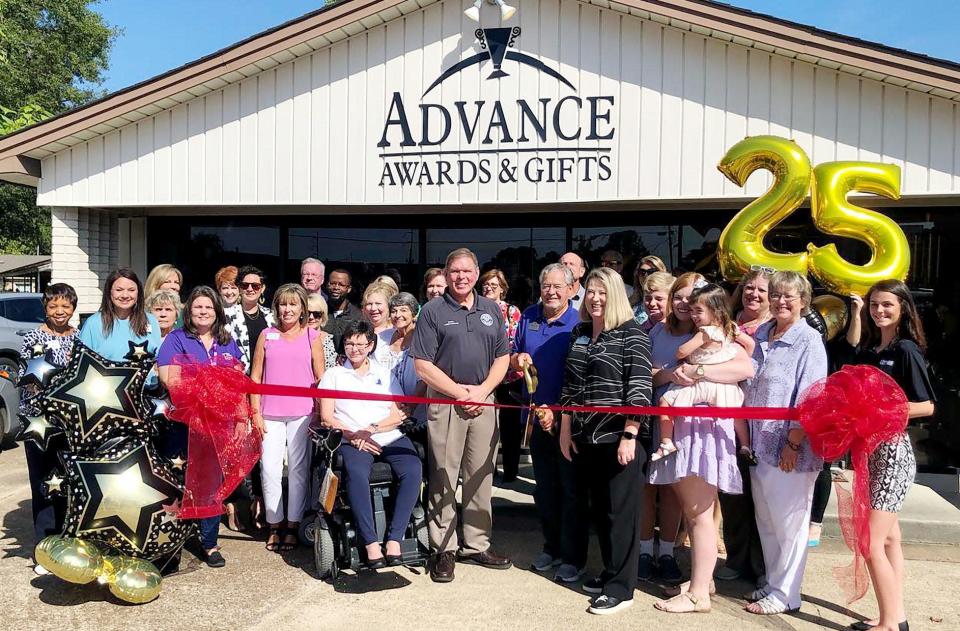 Advance Awards &amp; Gifts owners Larry and Terri Hensley with Bossier City Mayor Tommy Chandler during the Bossier Chamber of Commerce﻿ 25 year celebration.