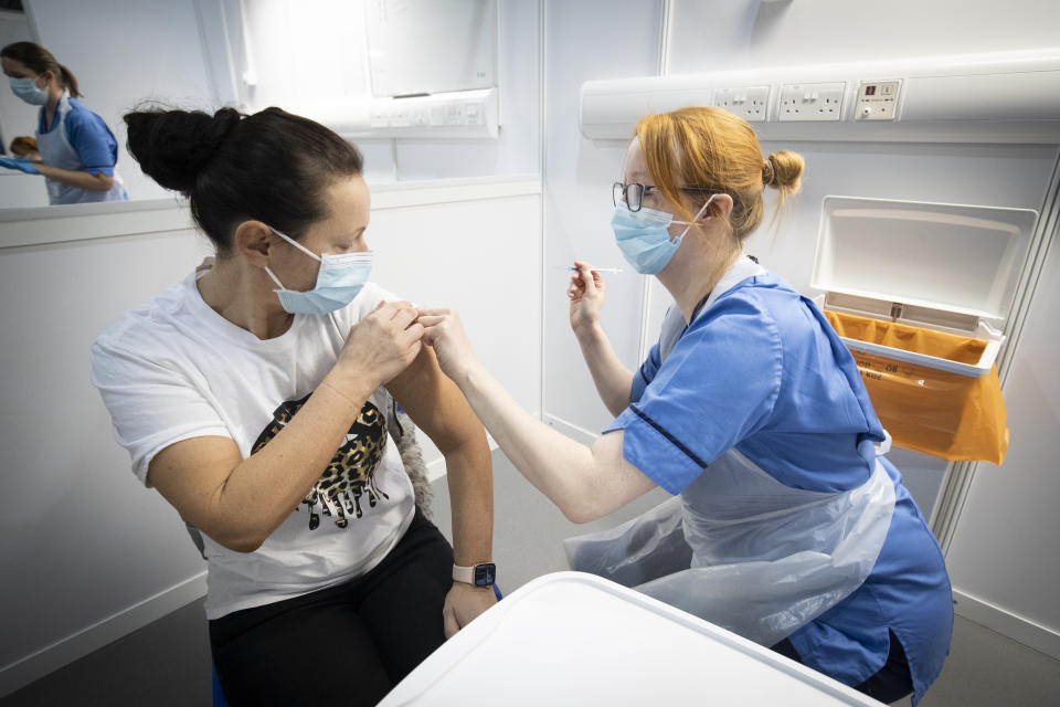 File photo dated 23/01/21 of a nurse giving a Covid-19 vaccine. The percentage of people in the UK who say they are likely to take a coronavirus vaccine has risen, but there remains a gap in willingness between white Britons and those from a minority ethnic background, a survey has suggested.
